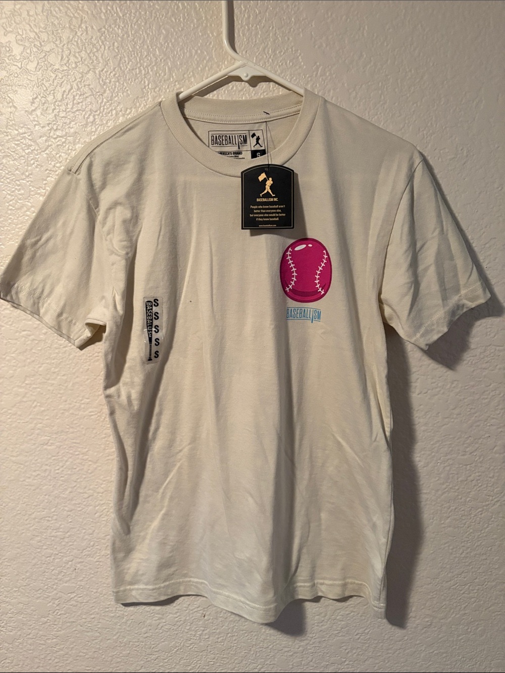 Baseballism Men’s Cream Short Sleeve Tee with Pink Baseball Graphic